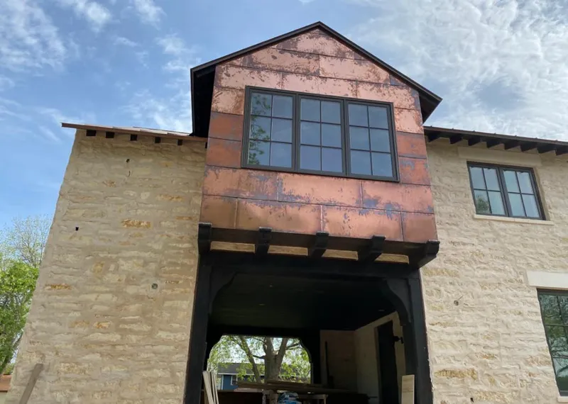 Copper metal panel facade on a stone building for Skylight Installation in Piedmont