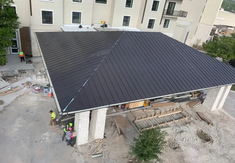 Metal roofing installation team working on a commercial building in Piedmont